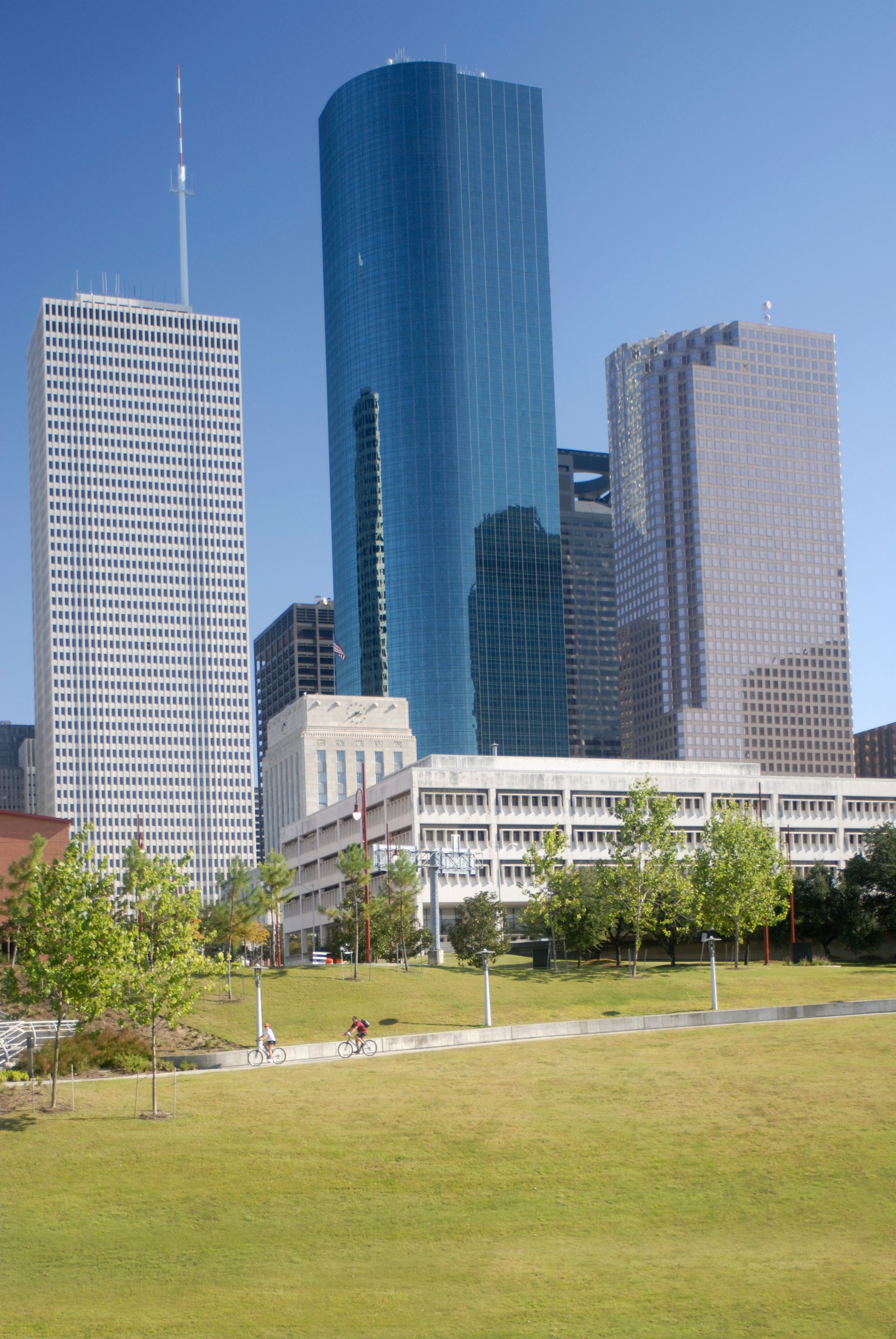 Riding Bicycles Past Skyscrapers